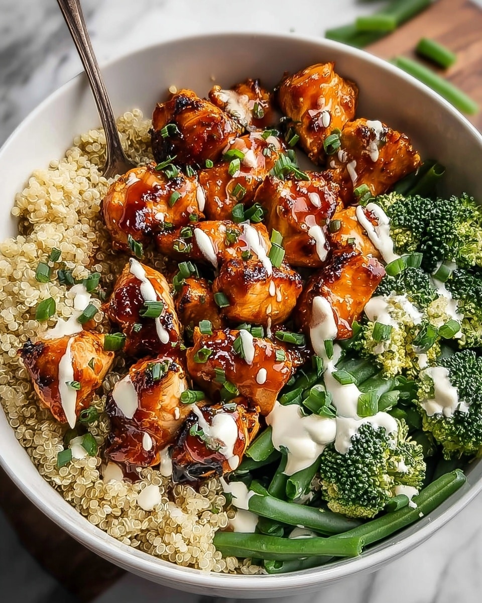 A white bowl filled with a base layer of white rice, topped with a layer of charred, glossy, golden-brown chicken pieces coated in sauce with some pieces showing the tender inside. Surrounding the chicken, vibrant green broccoli florets and snap peas add a fresh contrast. Small dollops of white creamy sauce are placed among the vegetables, and finely chopped green herbs are sprinkled evenly over the whole dish. The bowl is set against a soft white marbled surface, with a cup of reddish sauce blurred in the background. Photo taken with an iphone --ar 4:5 --v 7