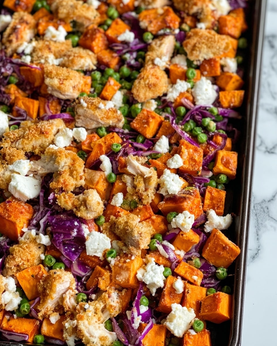 A close-up of a baking tray filled with roasted sweet potato cubes that are bright orange and slightly browned, mixed with small green peas scattered evenly throughout. There are crispy golden-brown pieces of breaded chicken scattered on top and intermixed with the vegetables. Small dollops of soft, white cheese are spread across the tray, contrasting with the other ingredients. Thin strands of purple cabbage add slight texture and color among the layers. The whole dish sits on a white marbled surface. photo taken with an iphone --ar 4:5 --v 7