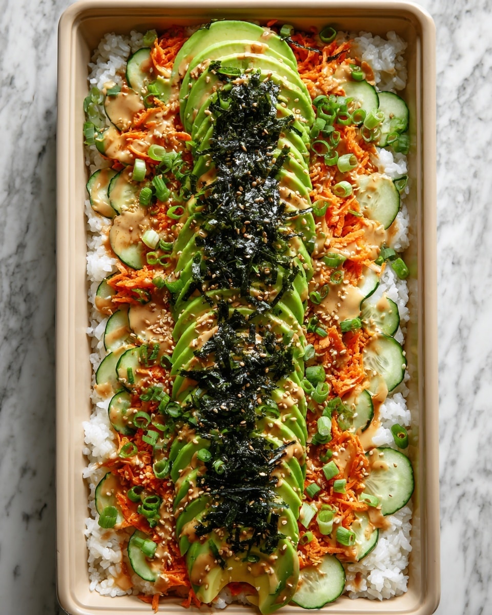 A rectangular beige dish filled with a base layer of white sushi rice, topped with a ring of thin cucumber slices around the edge. Inside the cucumber ring is a layer of shredded bright orange carrots with drizzles of a creamy, light brown sauce. On top, there are slices of ripe green avocado fanned out down the center of the dish, sprinkled with toasted sesame seeds. Over the avocado, strips of dark green, almost black seaweed are scattered, along with chopped green onions spread evenly across the top. The dish rests on a white marbled surface. photo taken with an iphone --ar 4:5 --v 7